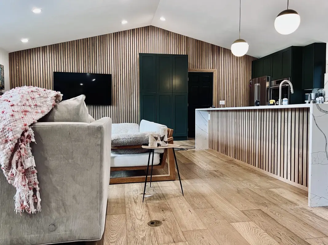 Living room with a full-height vertical slat accent wall