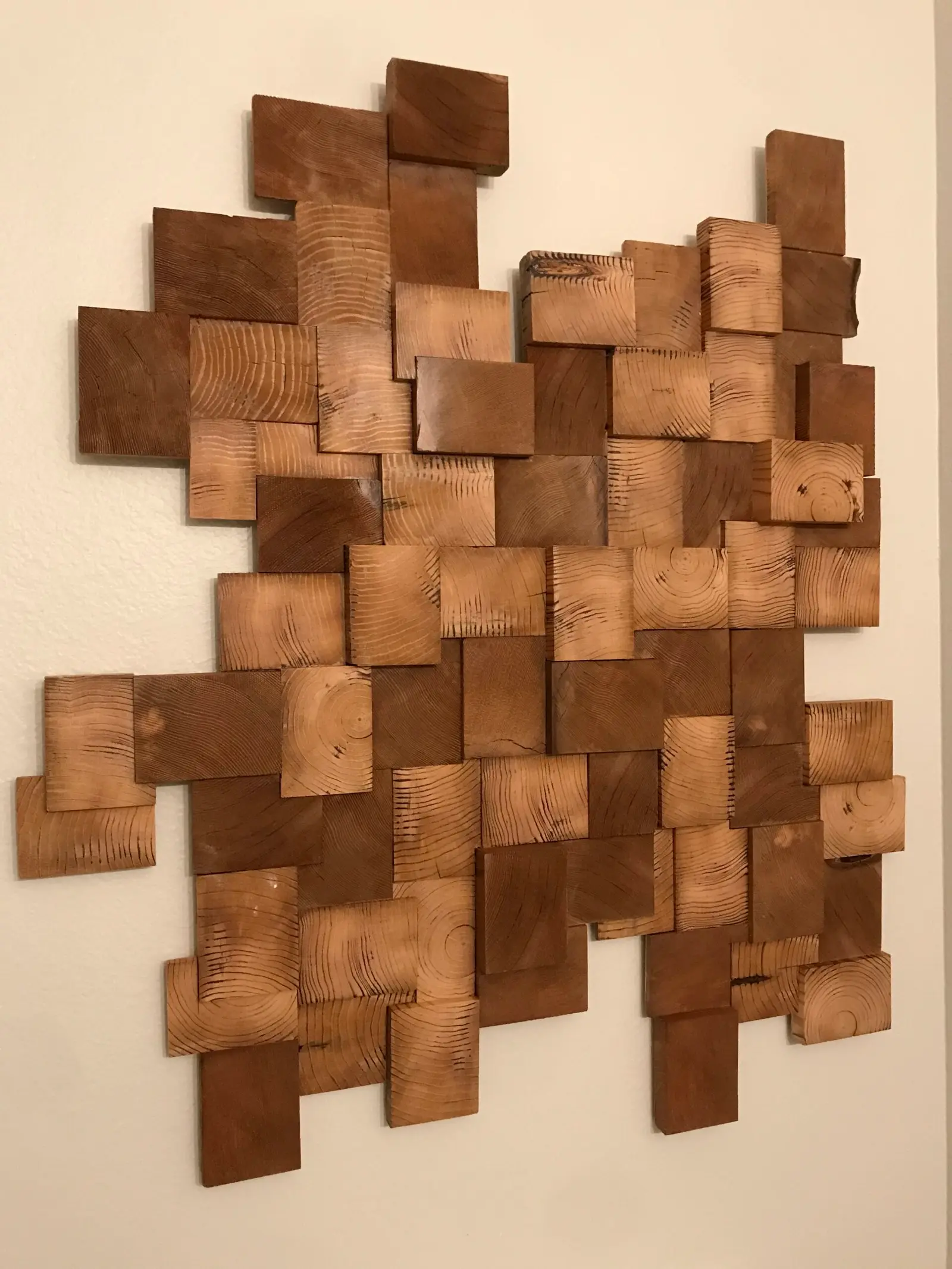 Wall art made from stacked wood blocks of varying sizes