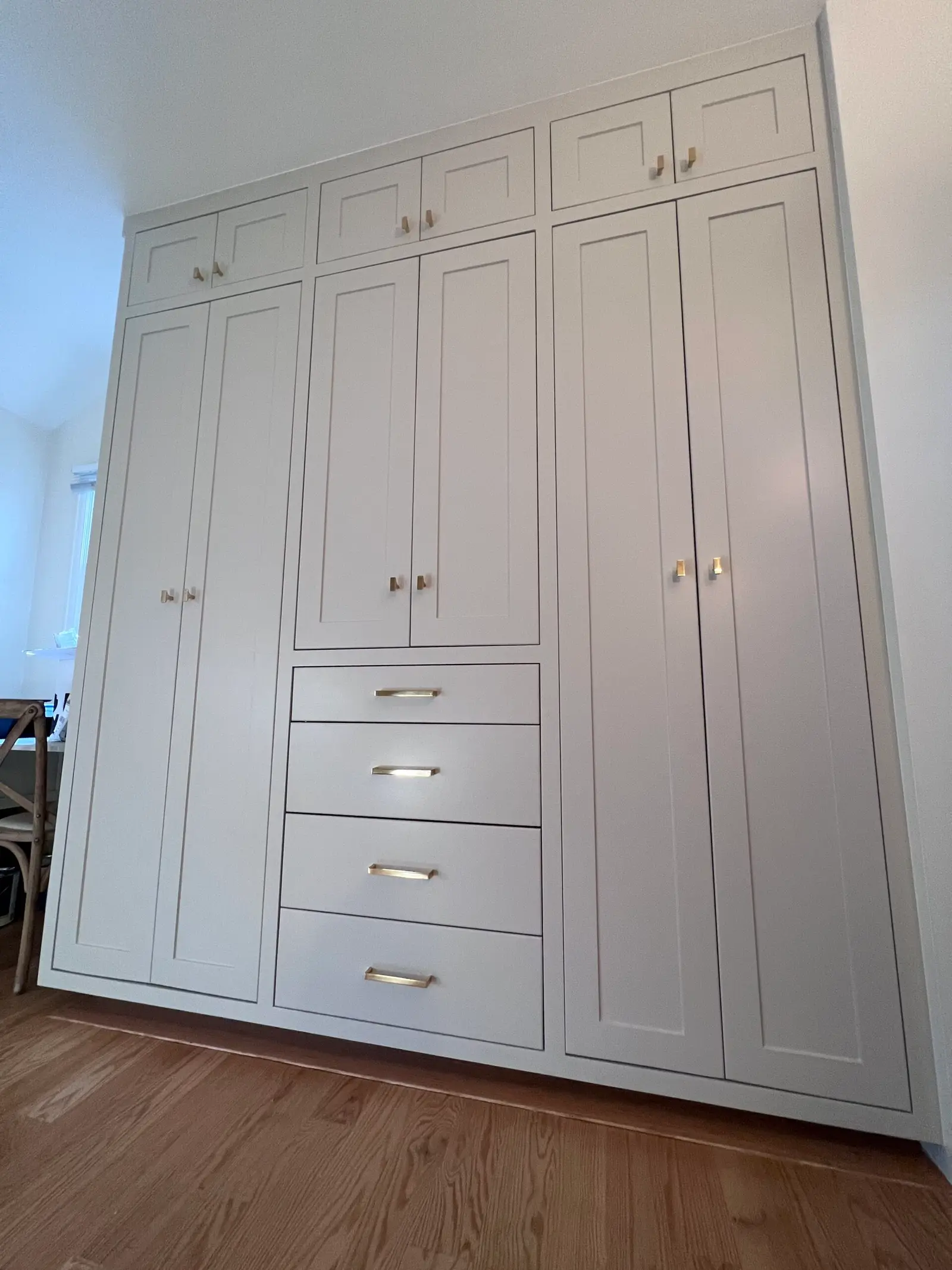 Full-height white built-in wardrobe cabinets with drawers
