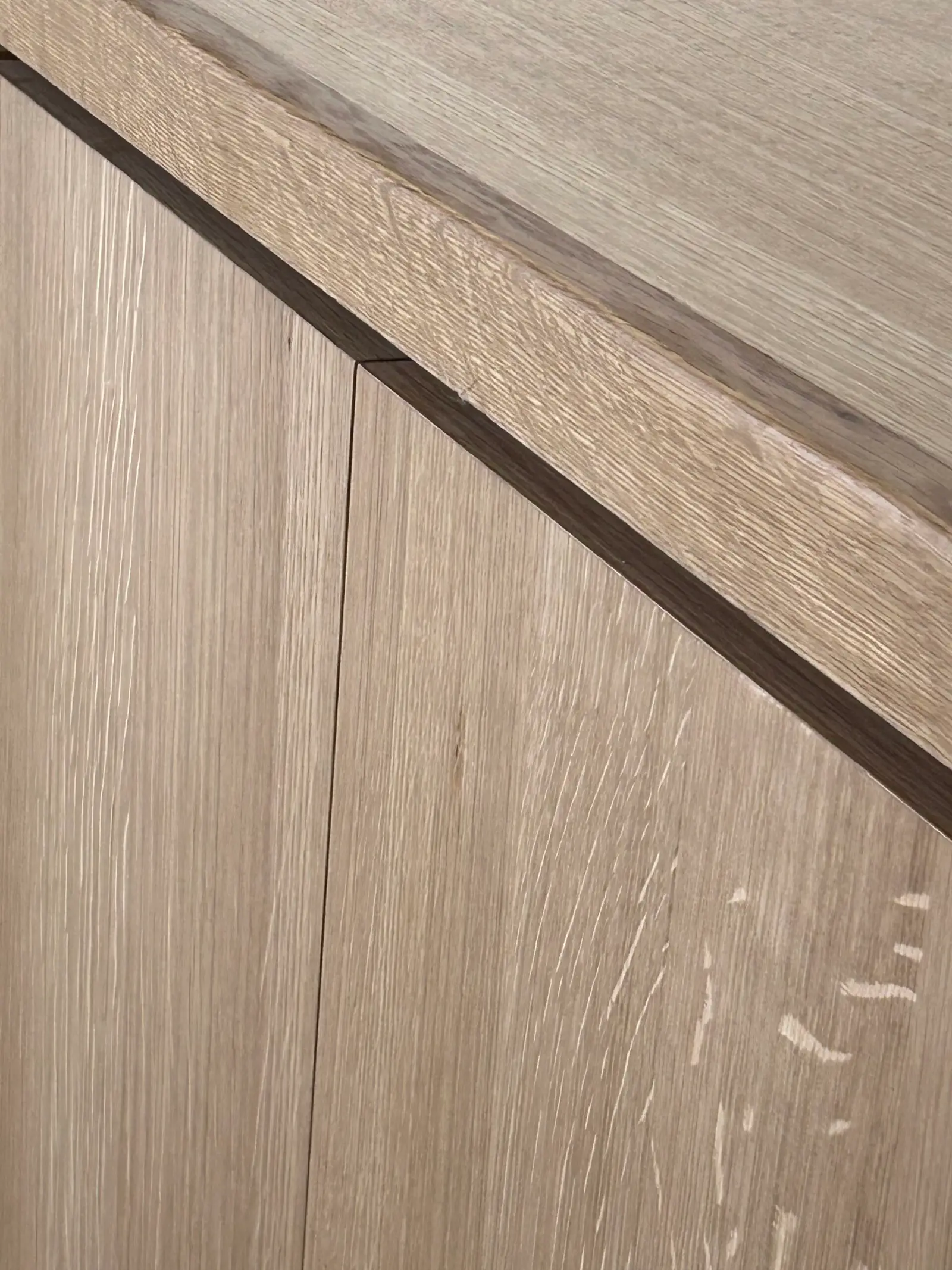 Close-up of a light wood panel seam and edge detail
